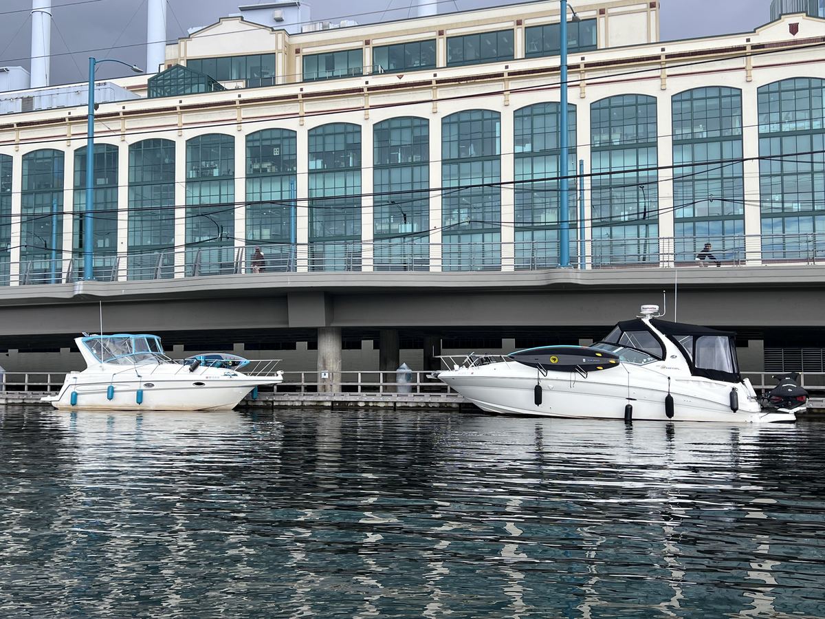 Cruisers with full canvas enclosures up at the dock — the fleet runs year-round