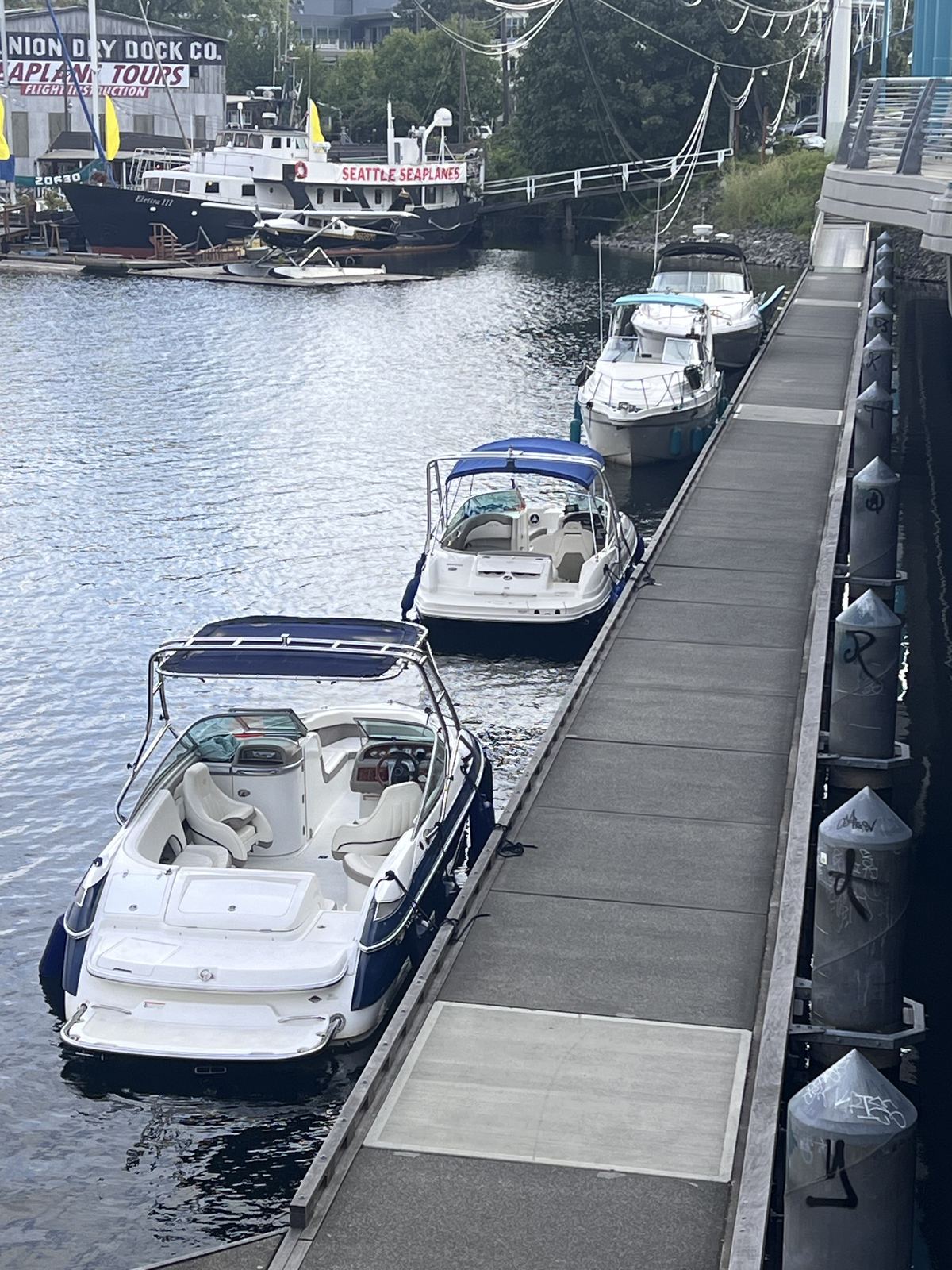 The public dock at 1151 Fairview Ave N — boats along the walkway, Seattle Seaplanes behind